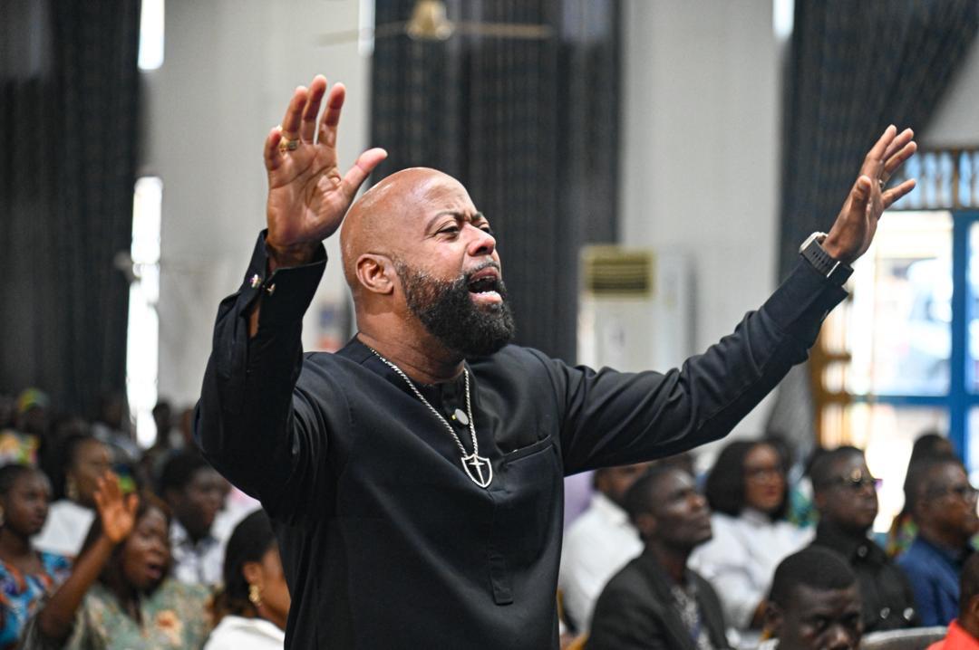 Bishop Richard worshipping with raised hands